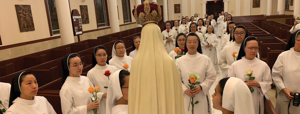 Catholic religious sisters venerate the Pilgrim Statue of Our Lady of Fatima