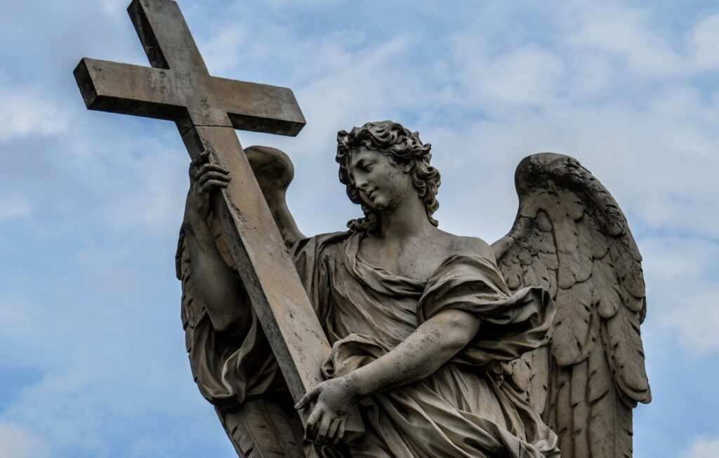 A statue of an angel holding a cross